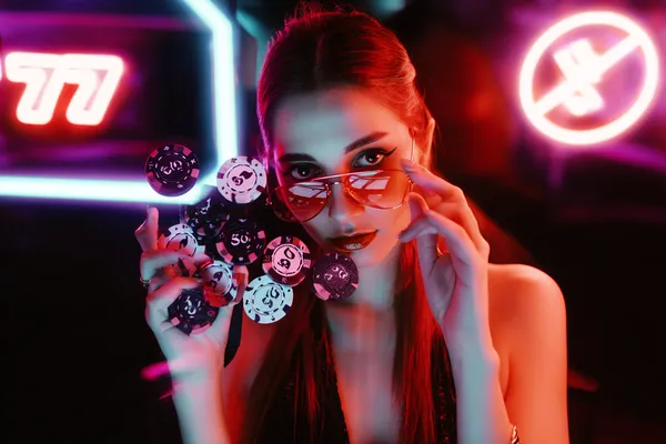 A glamorous woman holding casino chips in a neon-lit environment, representing the premium online casino atmosphere of 7555BETT.